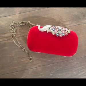 Red clutch purse with peacock clasp